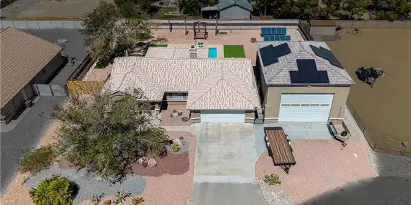 Image 3: An aerial perspective showcases a tile-roofed home