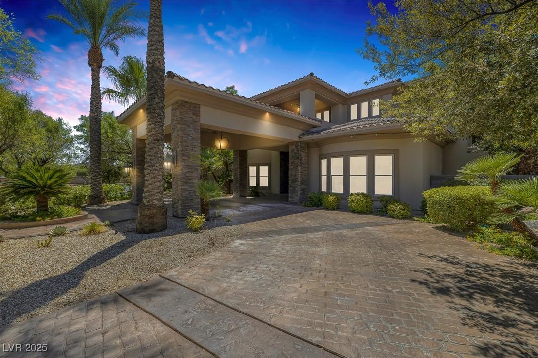 Image 4: Doorway to property with stone siding, stucco sidi