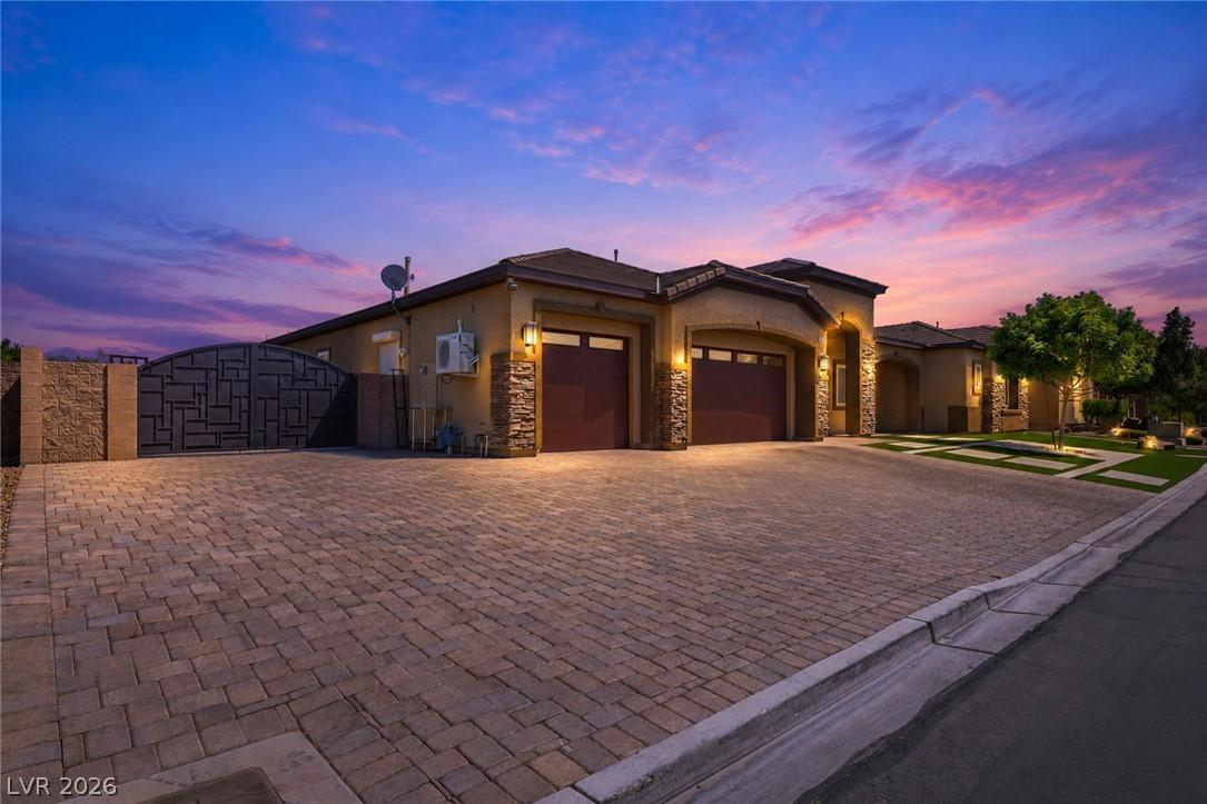 Image 2: An inviting exterior with a brick paver driveway a