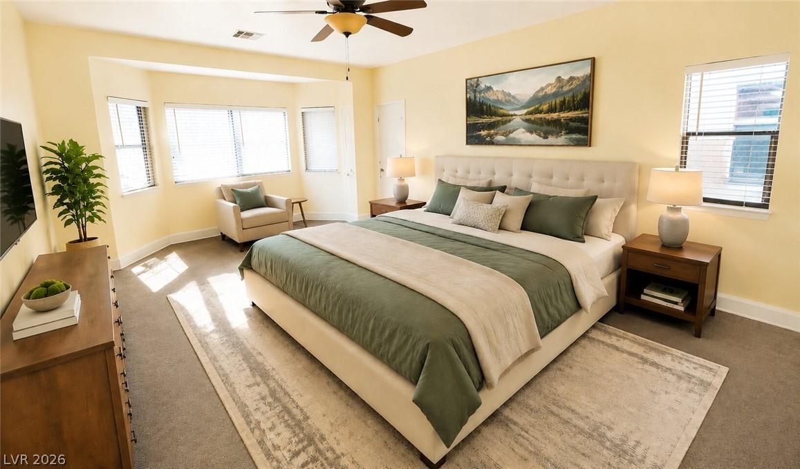 Image 4: Natural light floods this spacious bedroom, offeri