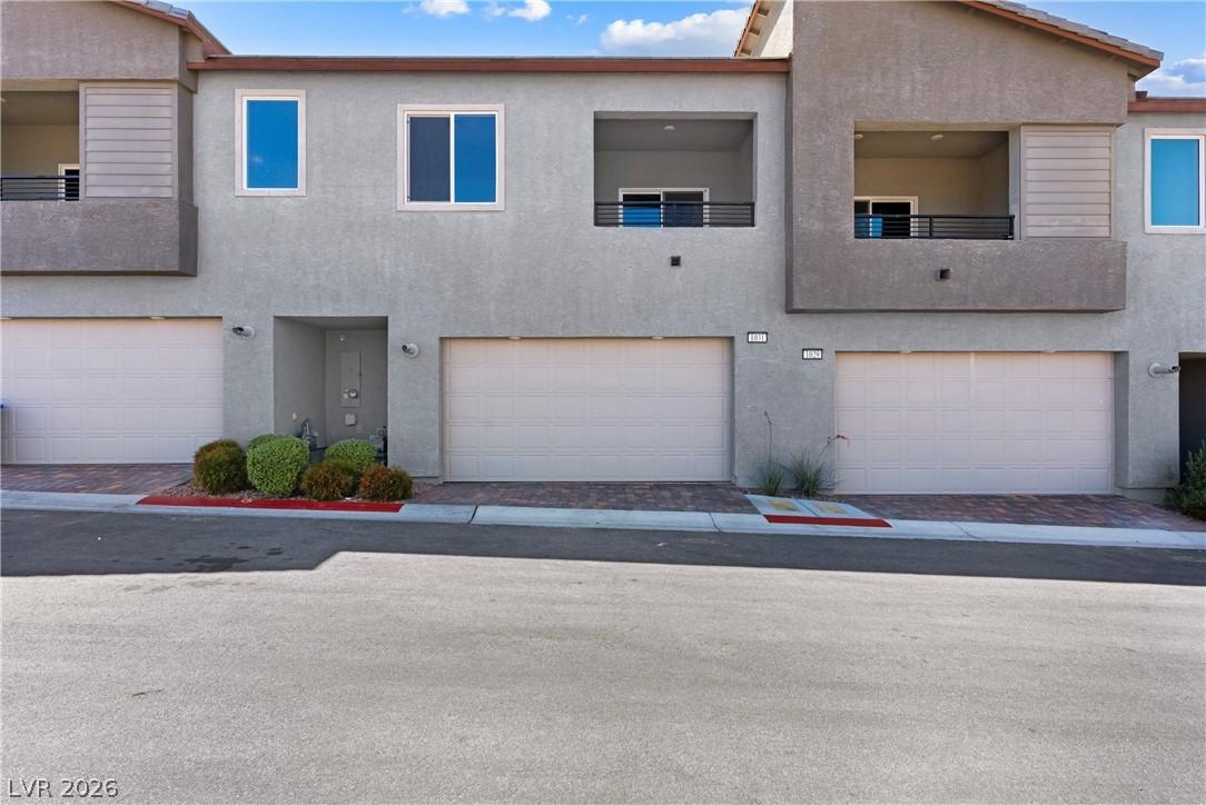 Image 2: Attached garage provides convenience and modern li
