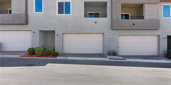 Image 2: Attached garage provides convenience and modern li