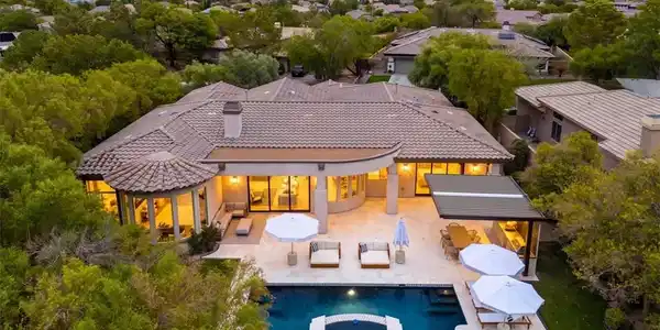 Image 3: An aerial view showcases a grand residence with a