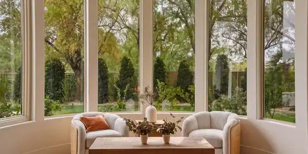 Image 4: Natural light floods this inviting sitting room, o
