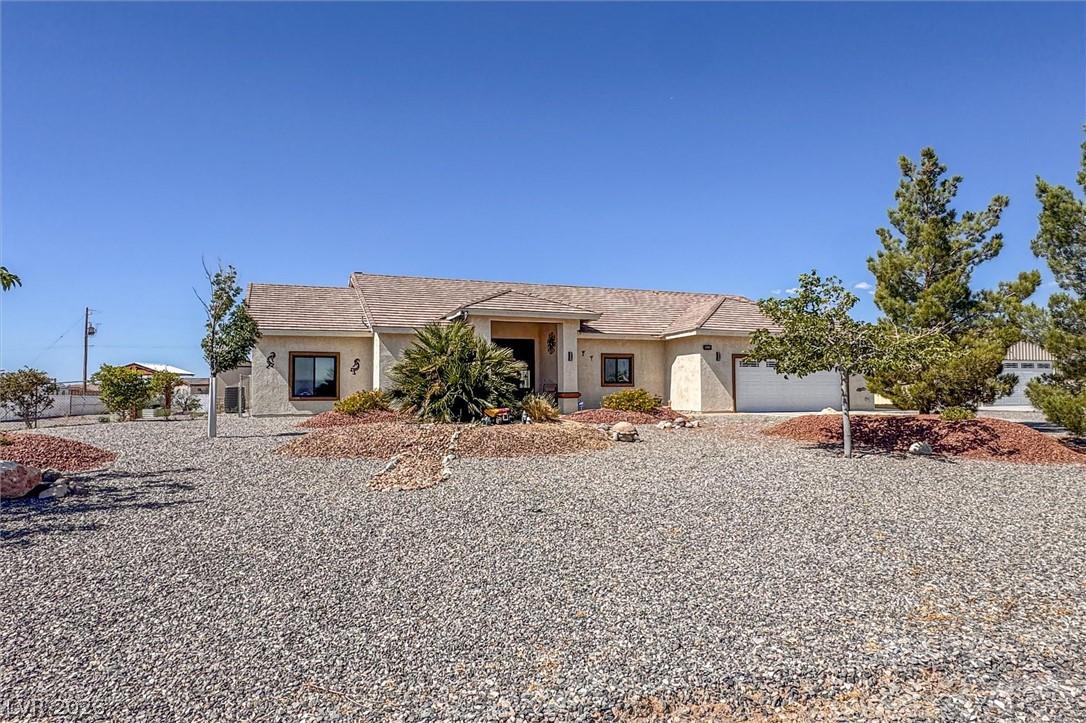 Image 1: A desert-friendly landscape surrounds this charmin