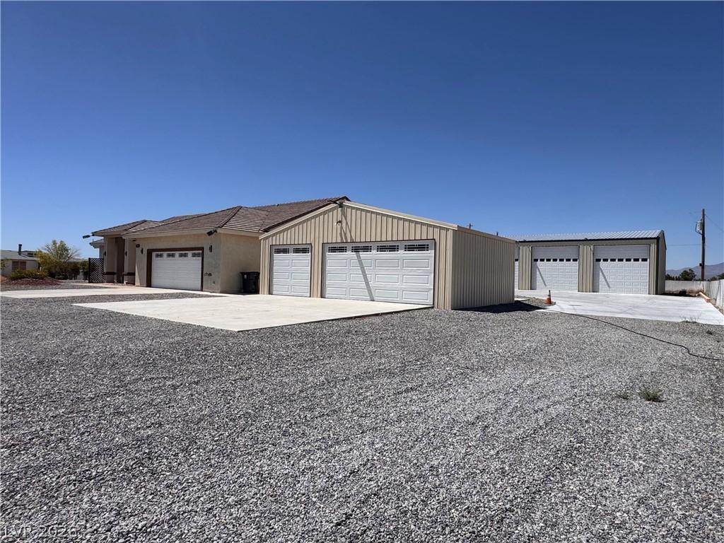 Image 3: Ample parking and multiple outbuildings offer supr