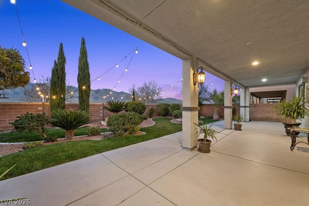 Image 1: The home features an expansive covered patio along
