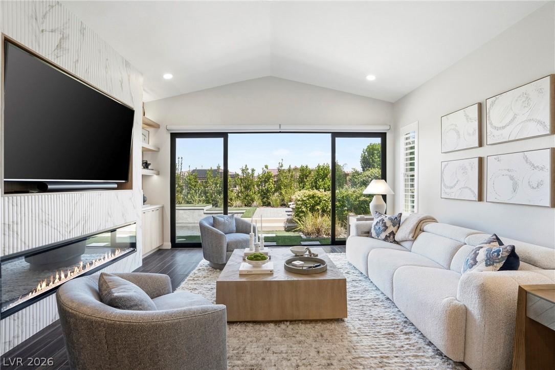 Image 1: This bright living space features an elegant firep