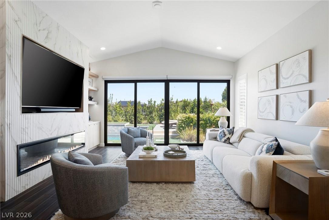 Image 2: Bright and airy living area with a sleek fireplace