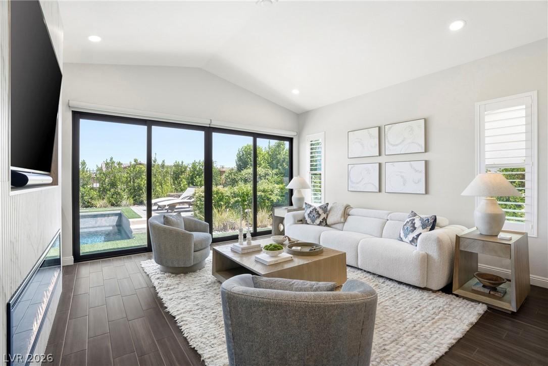 Image 3: This bright living space offers vaulted ceilings,