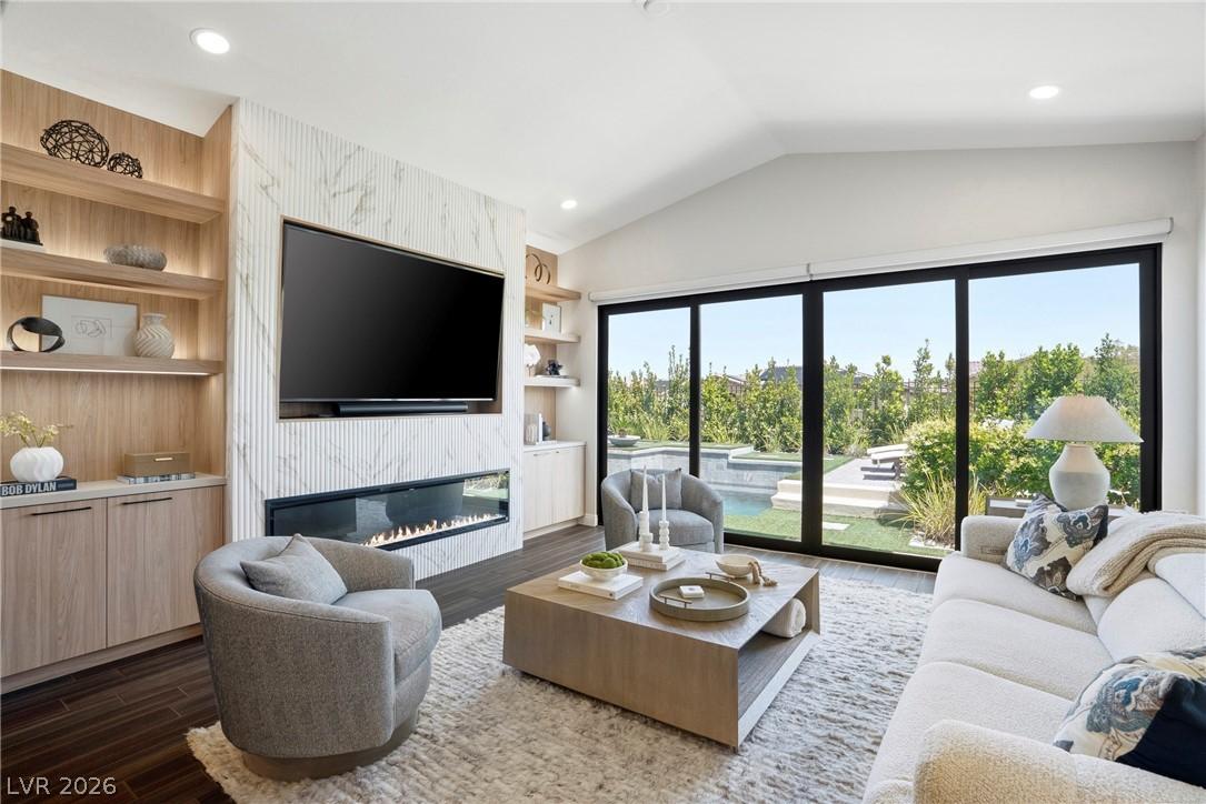 Image 4: This bright living space opens to a lush outdoor a