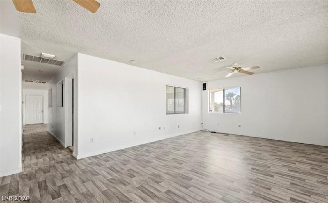 Image 4: This expansive living space features durable floor