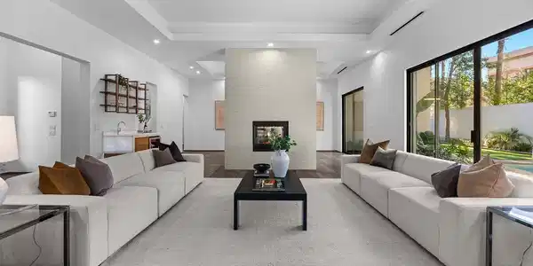 Image 3: A spacious living room features an inviting firepl