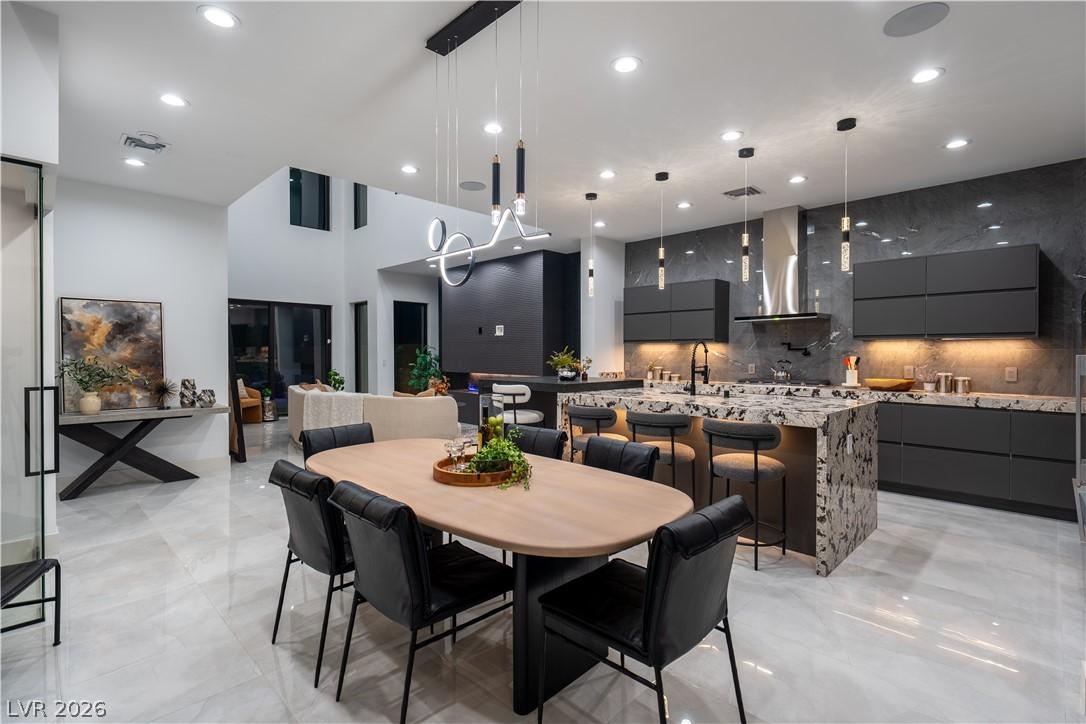 Image 3: This open concept space features a dining area, a