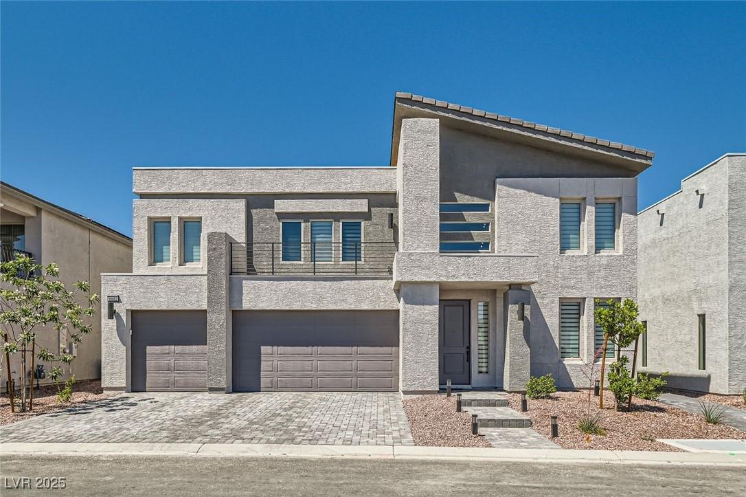 Image 2: Modern home with decorative driveway, an attached