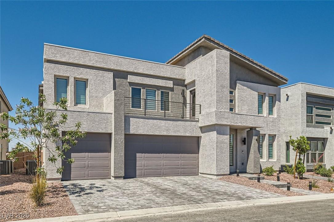 Image 3: Modern home with a balcony, a garage, decorative d