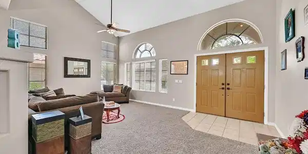 Image 3: An inviting entry opens to a spacious living room