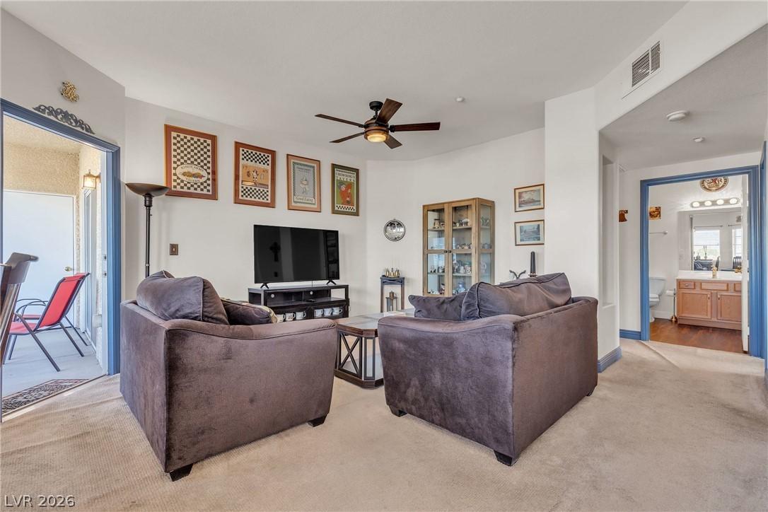 Image 4: Comfortable living space featuring a ceiling fan a