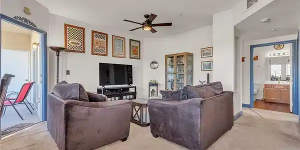 Image 4: Comfortable living space featuring a ceiling fan a