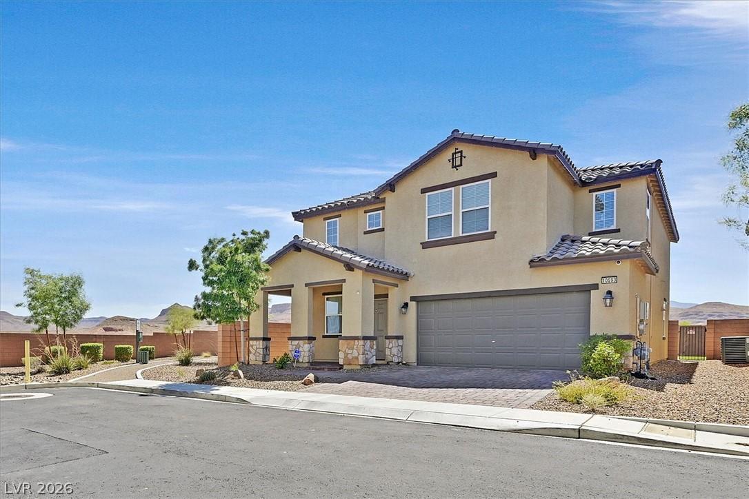 Image 2: Two-story home with a covered entryway and a two-c