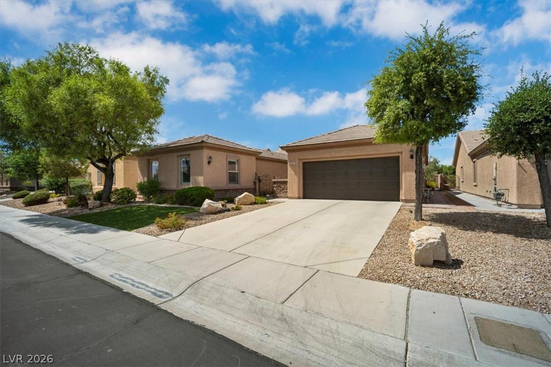 Image 2: A well-maintained concrete driveway leads to a cha