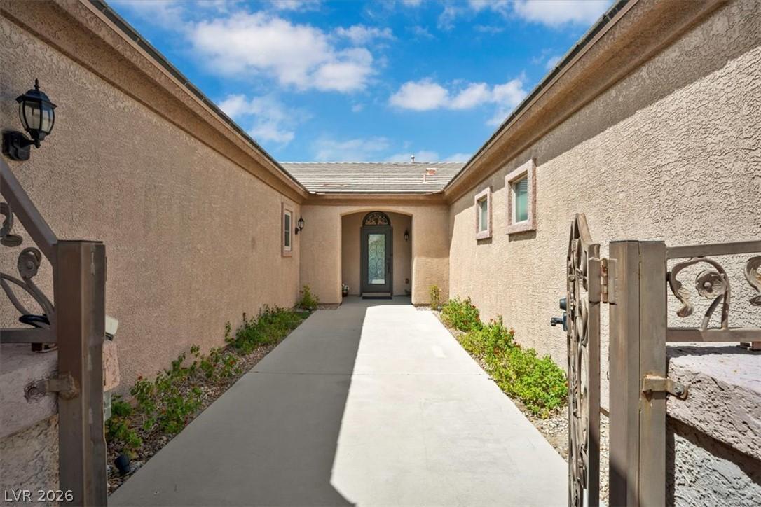 Image 4: An inviting gated walkway leads to the elegant ent