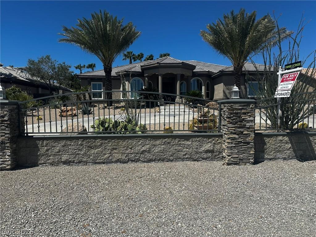 Image 1: A desert oasis with a charming stone facade and ma