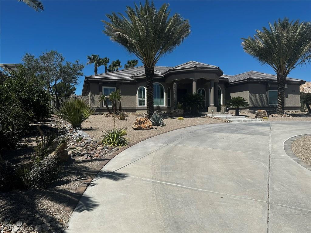 Image 3: A graceful circular driveway leads to a distinguis