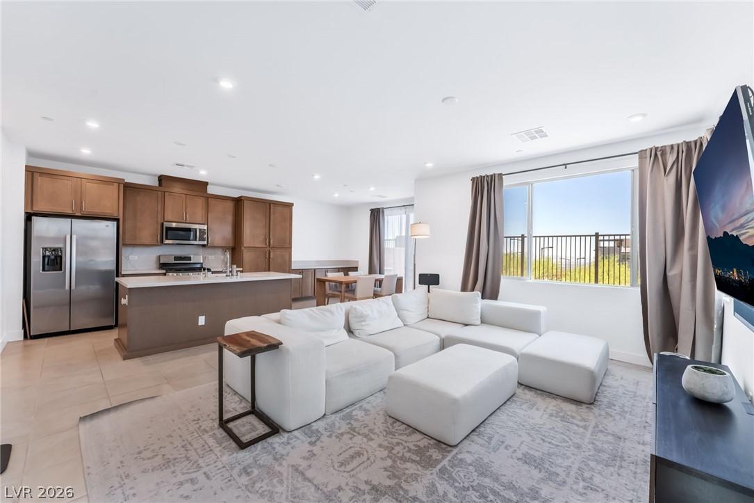 Image 2: An open concept living area seamlessly blends a co