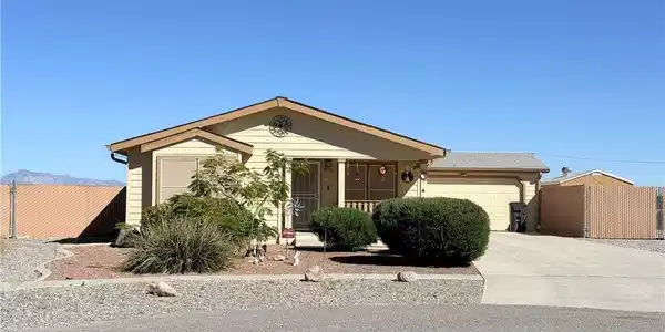 Image 2: A well-maintained single-story residence with a co