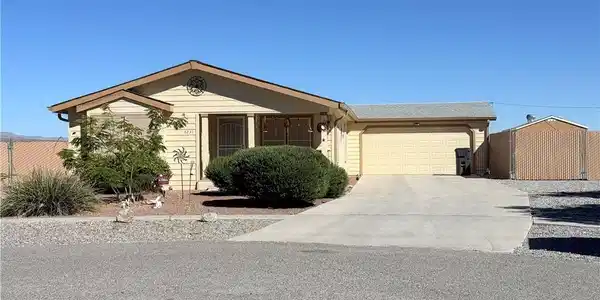 Image 3: This single-story home with an attached garage and