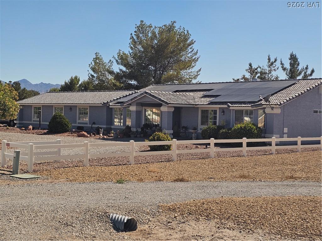 Image 1: A spacious ranch-style residence with solar panels