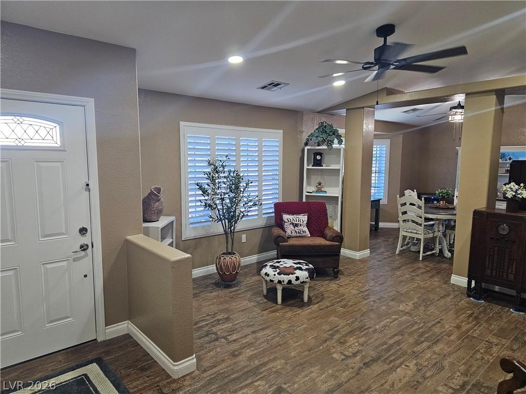 Image 3: Natural light illuminates rich wood-look flooring