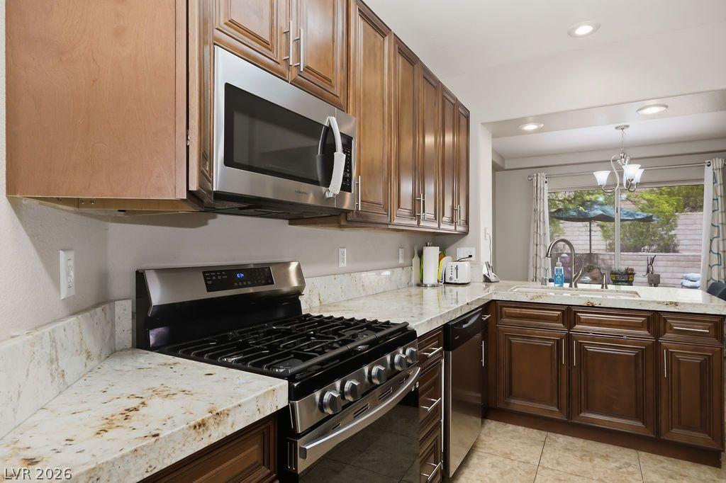 Image 1: Granite counters and rich wood cabinetry define th