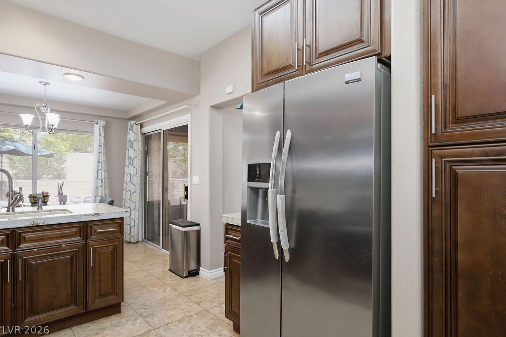 Image 4: A contemporary kitchen features rich cabinetry, lu