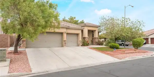 Image 2: A well-maintained facade features a double garage