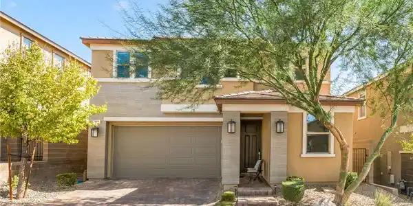 Image 3: A modern two-story exterior showcases stone accent