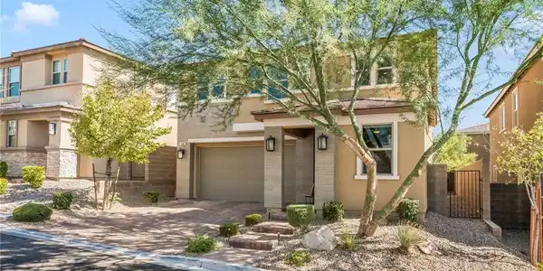 Image 4: A paved driveway leads to the integrated garage of