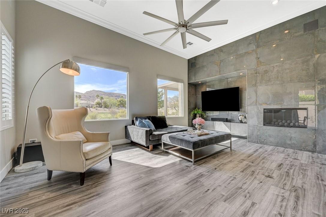 Image 3: Living room featuring crown molding, wood finished