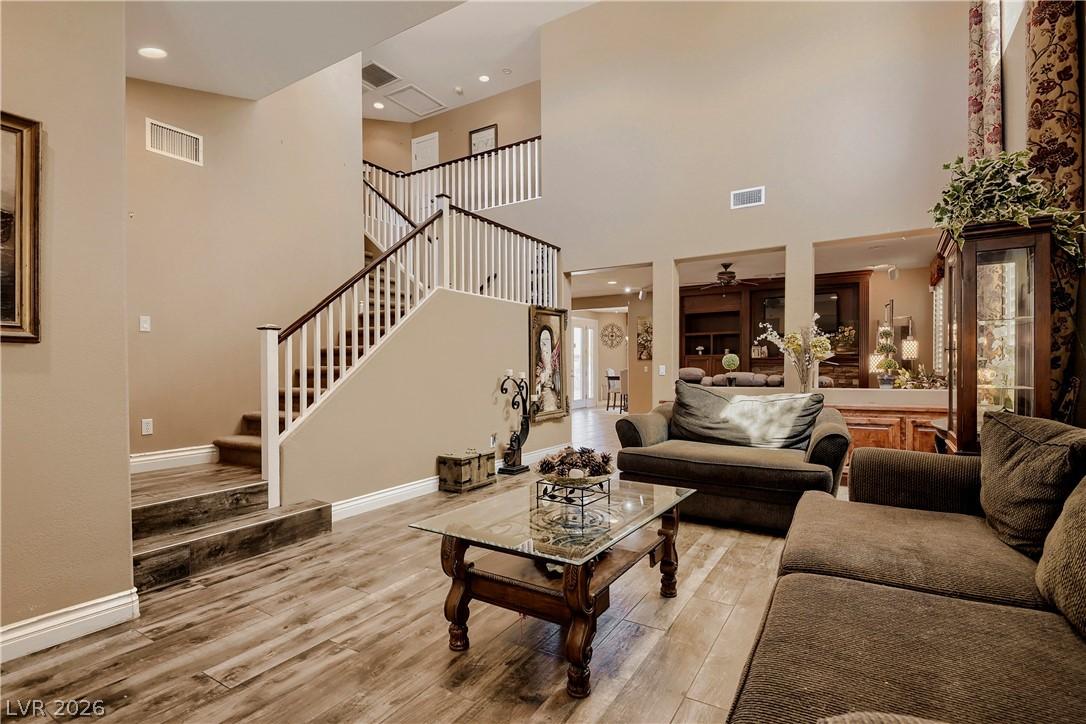 Image 3: A grand staircase ascends within this airy, natura