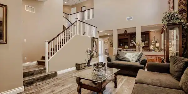 Image 3: A grand staircase ascends within this airy, natura