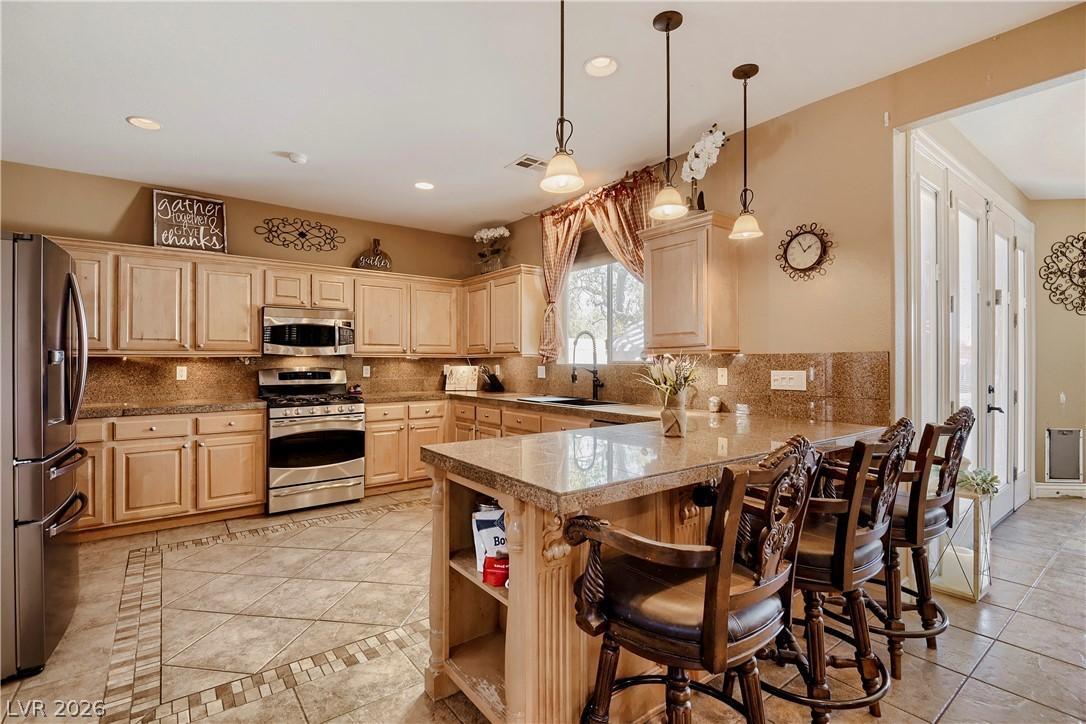 Image 4: A well-appointed kitchen boasts sleek stainless st