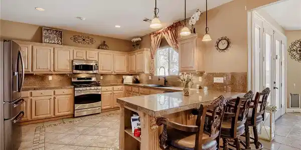 Image 4: A well-appointed kitchen boasts sleek stainless st