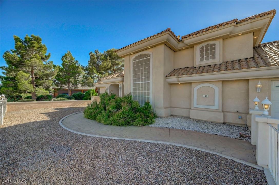 Image 4: A graceful driveway leads to this architecturally
