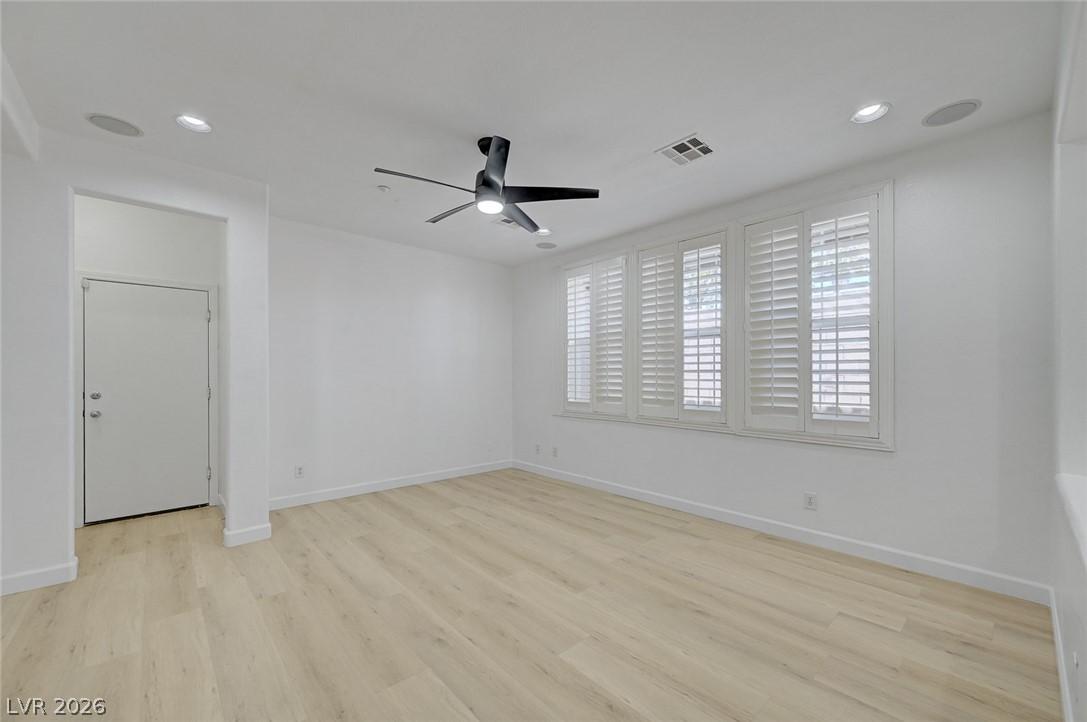 Image 3: Bright, airy room with elegant plantation shutters