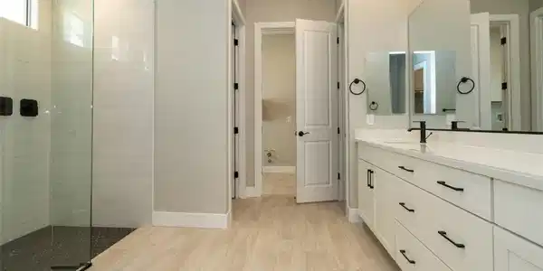 Image 4: Bathroom with vanity, walk in shower, and light wo