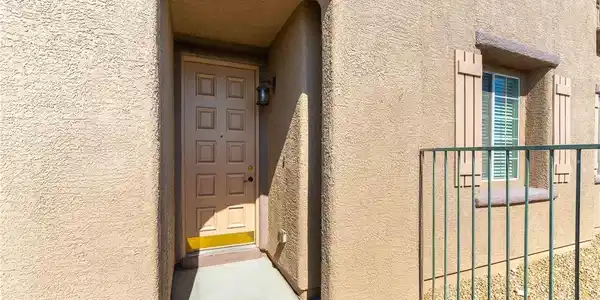 Image 3: The inviting entrance features a warm-toned door a