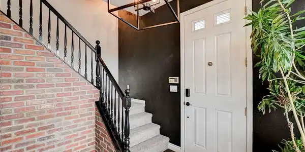 Image 4: A striking entry features a brick accent wall and