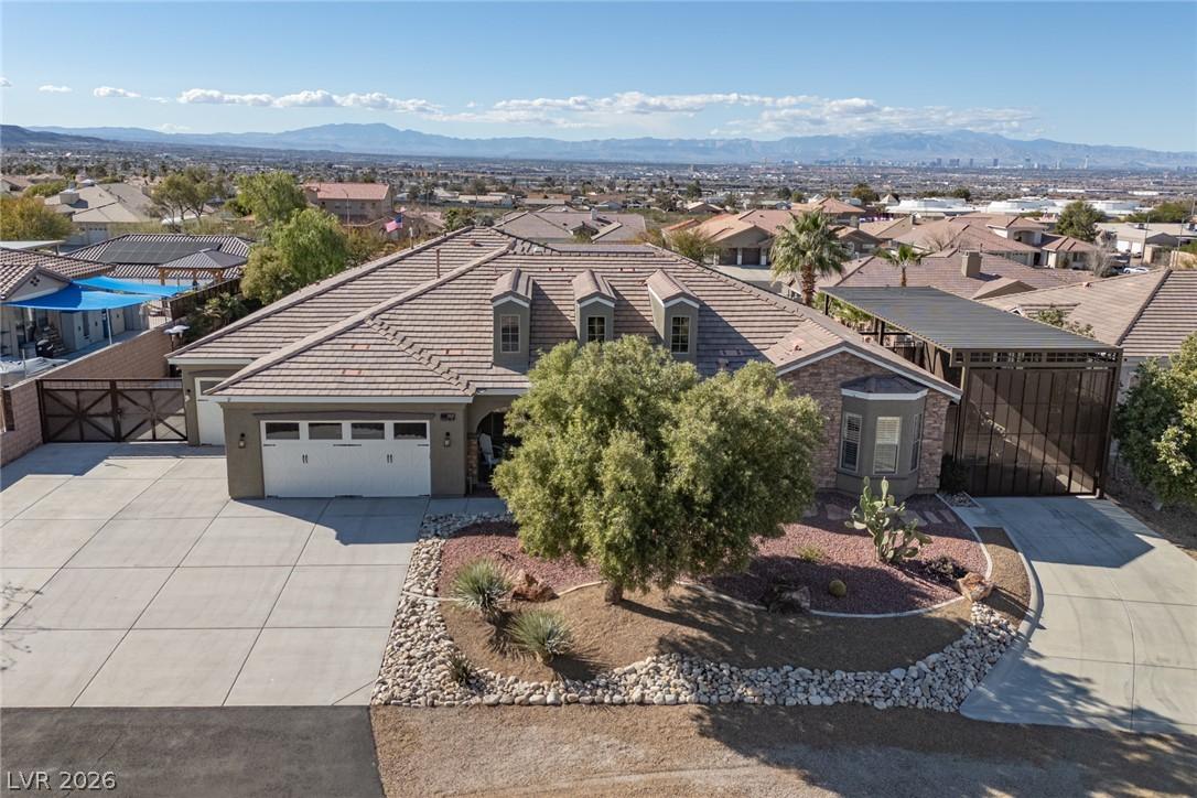 Image 2: An inviting exterior with a wide driveway and meti