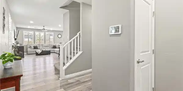 Image 4: Smooth wood-look flooring guides the eye through t